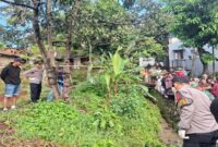 Petugas kepolisian melakukan olah TKP penemuan mayat pria di sebuah selokan Desa Sukalilah, Cibatu, Garut